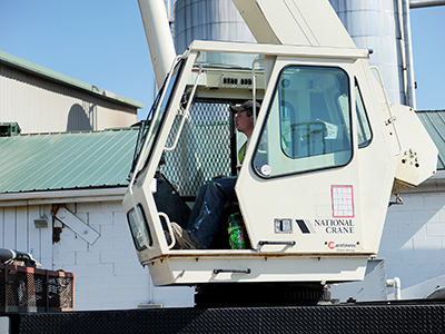 A Zartman Construction crane operator works one of the team