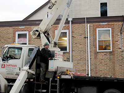 A Zartman Construction crane operator works one of the team