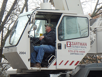 Crane operator Andrew Switzer works one of the team