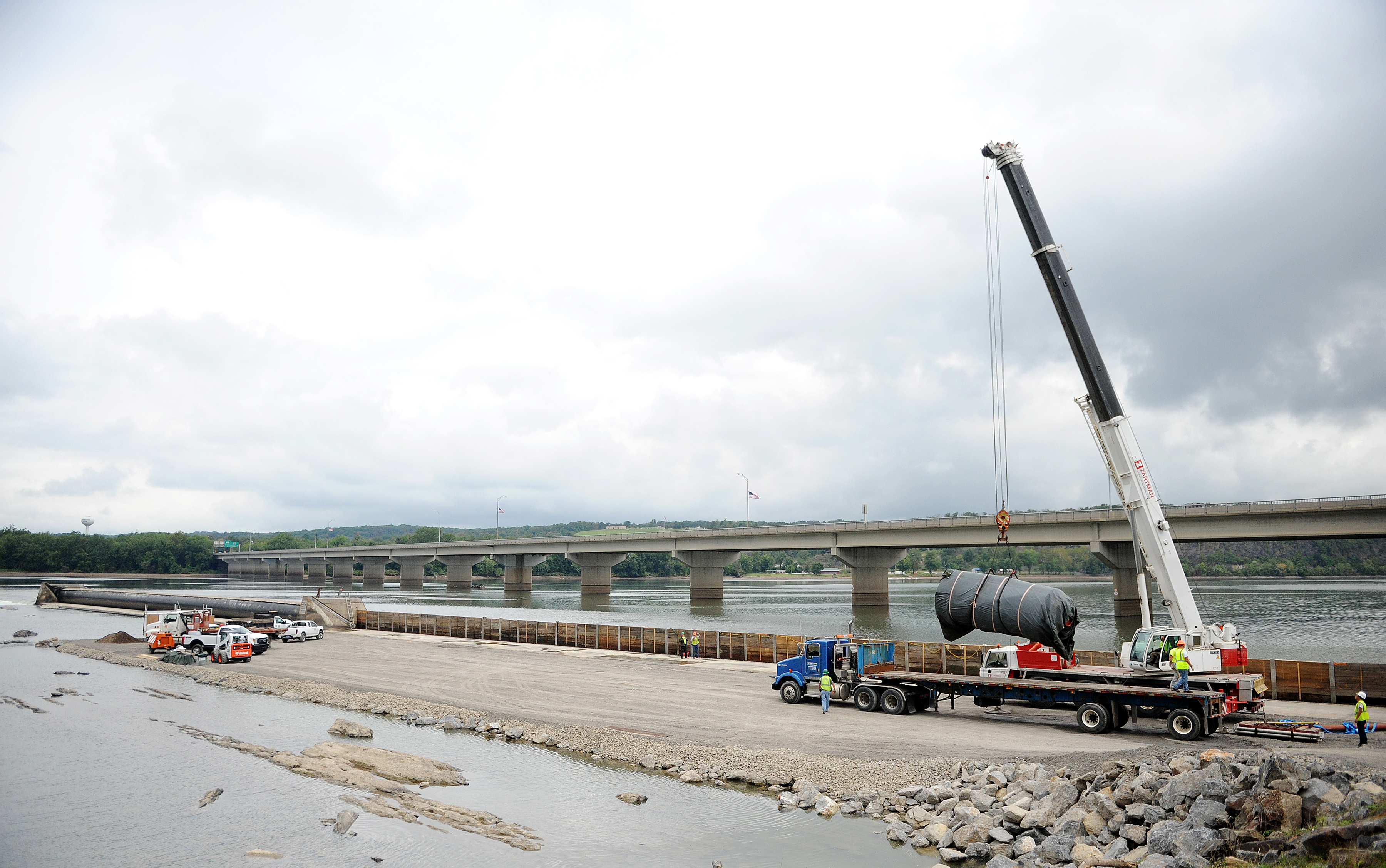 A section of the Adam T. Bower Dam is set into place after being repaired.