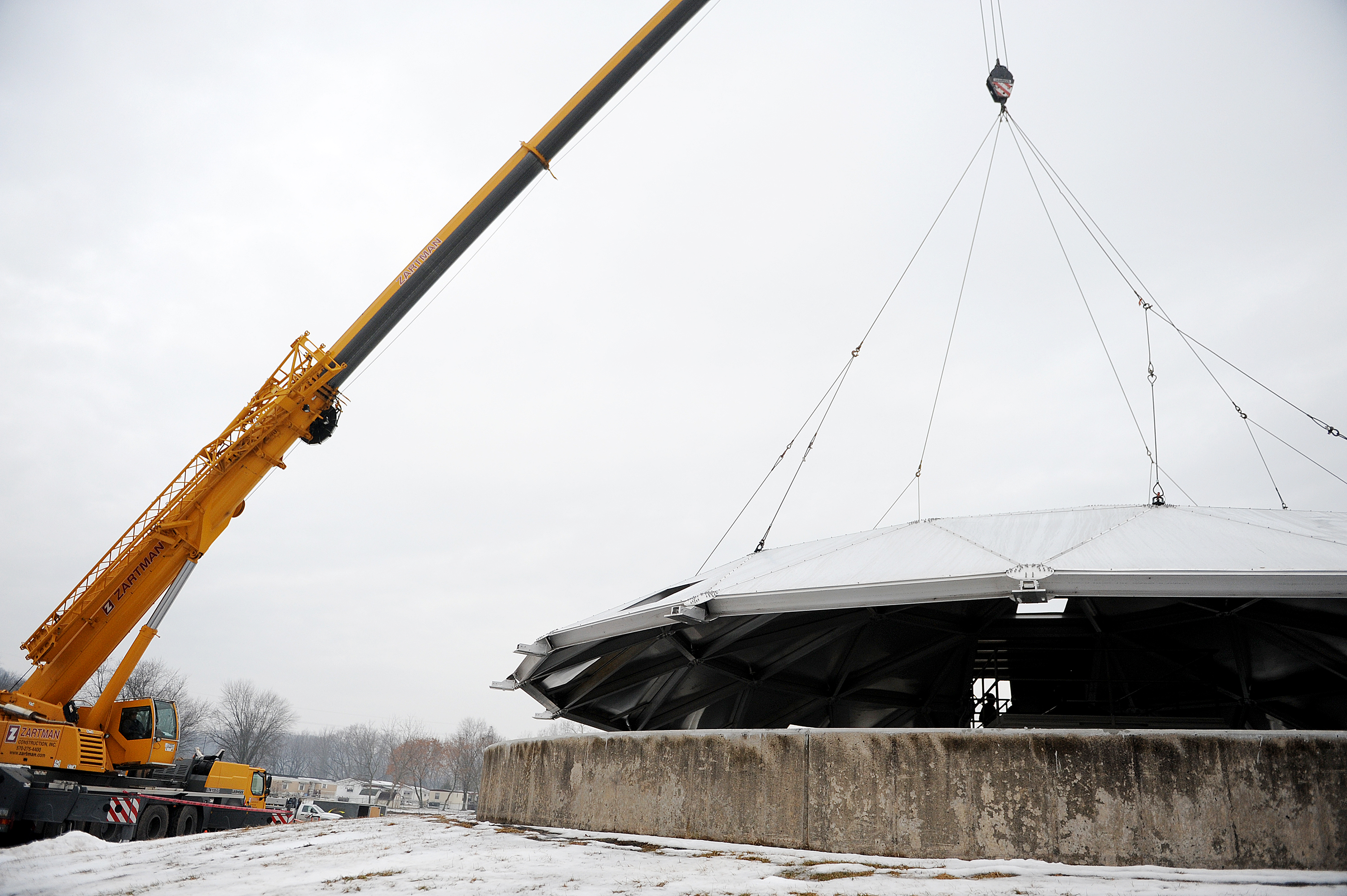 A Zartman Construction Inc. crane lowers the lid on to a clarifier at the Danville Water Treatment Plant.