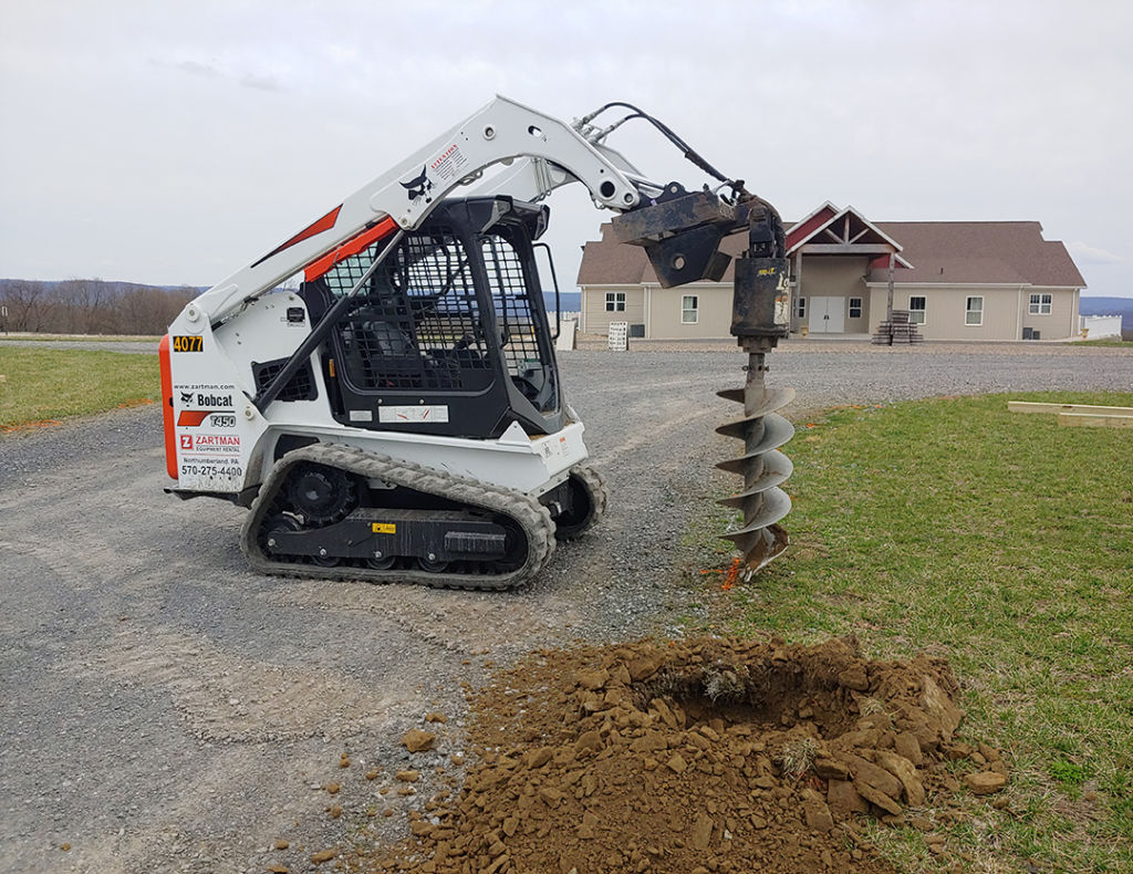 Bobcat Compact Skid Loader Rental with auger attachment