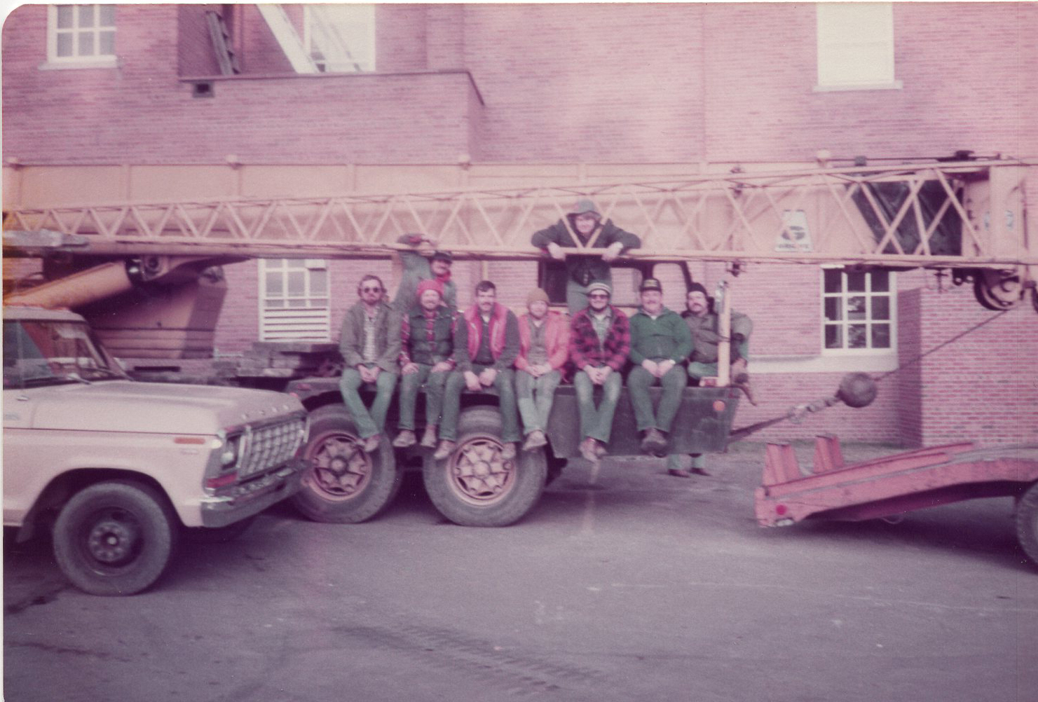 Group of Zartman Construction team members sit on a trailer